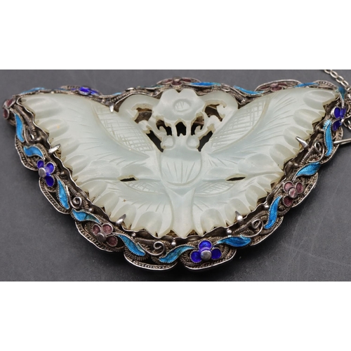 422 - A silver and jade brooch in the form of a butterfly with enamel decoration with pierced motifs, 7cm ... 