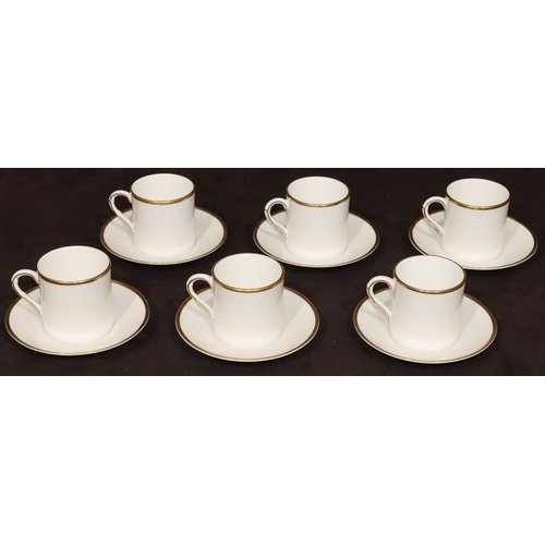 84 - A set of 6 Royal Worcester coffee cans and saucers on white ground with various multi-coloured flora... 