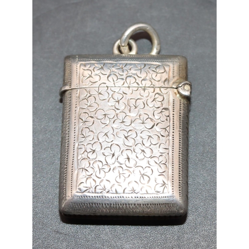 221 - A small Victorian silver vesta case with allover chased and leaf decoration and hinged lid, Birmingh... 