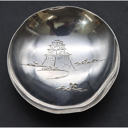 264 - A Japanese 1000 silver coloured metal small circular dish with engraved building motif on sweeping f... 