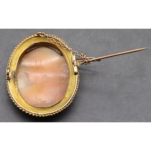 395 - A 19th Century oval gold frame cameo with raised figurehead of a lady with hearts plaited in her hai... 