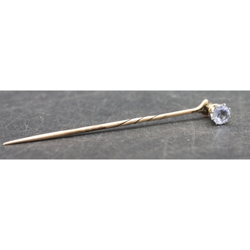 396 - A gold stickpin mounted with a pale blue stone, 1.6 grams gross