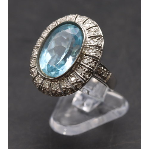 439 - A white gold large oval ladies' cluster ring set with aquamarine surrounded by small diamonds, size ... 