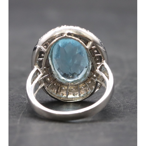 439 - A white gold large oval ladies' cluster ring set with aquamarine surrounded by small diamonds, size ... 