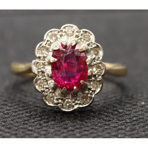 441 - An 18ct gold ladies' oval cluster ring set with centre ruby surrounded by diamonds, size K, 3.3 gram... 