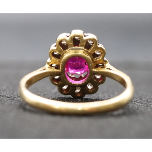 441 - An 18ct gold ladies' oval cluster ring set with centre ruby surrounded by diamonds, size K, 3.3 gram... 