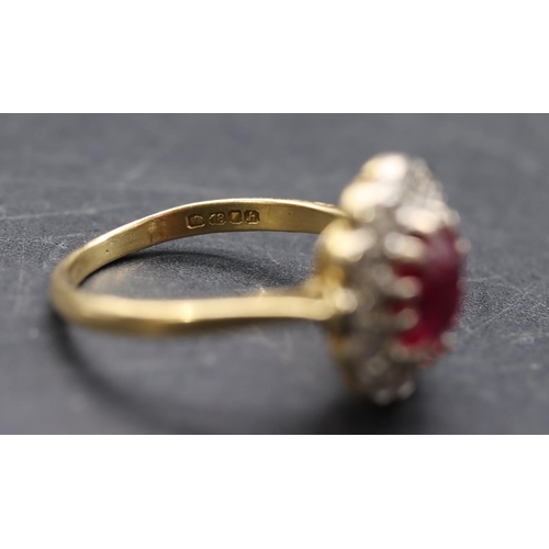 441 - An 18ct gold ladies' oval cluster ring set with centre ruby surrounded by diamonds, size K, 3.3 gram... 