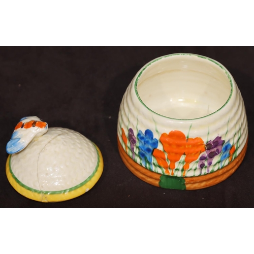 60 - A Clarice Cliff Bizarre Crocus pattern jam pot in the form of a beehive with cover (cover cracked), ... 