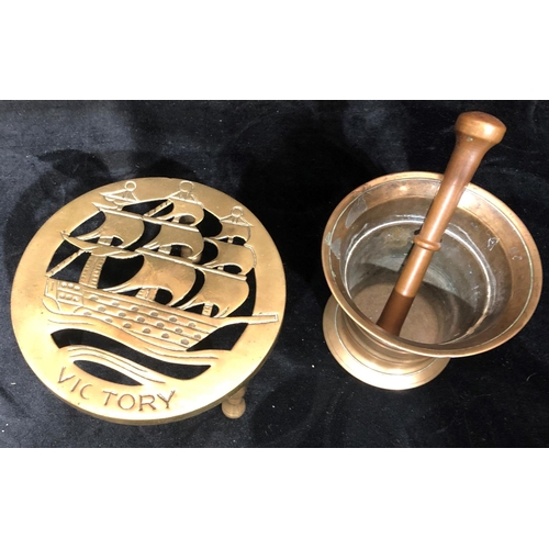 8035 - A brass HMS Victory trivet, 15cm diameter, 7cm high and a bronze pestle and mortar, top 12cm diamete... 