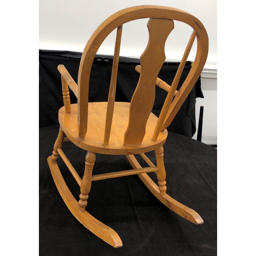 8051 - A child's small rocking chair, 62cm high (slight split to wood on both arms.