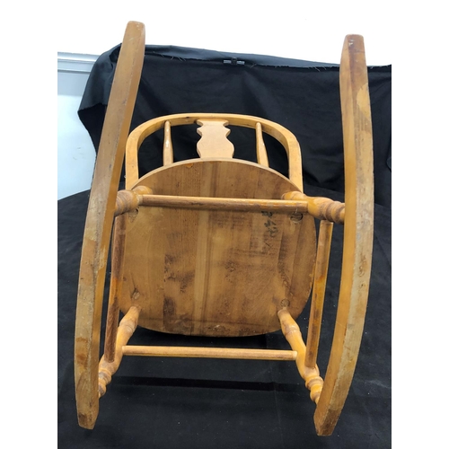 8051 - A child's small rocking chair, 62cm high (slight split to wood on both arms.