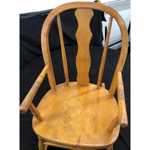 8051 - A child's small rocking chair, 62cm high (slight split to wood on both arms.