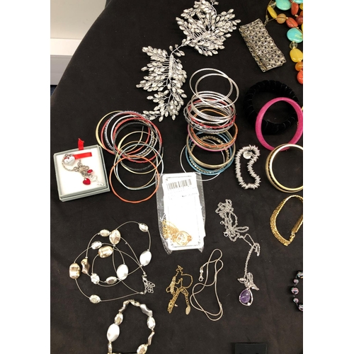 8067 - A large quantity of costume jewellery, necklaces, brooches, bracelets, earrings, etc.