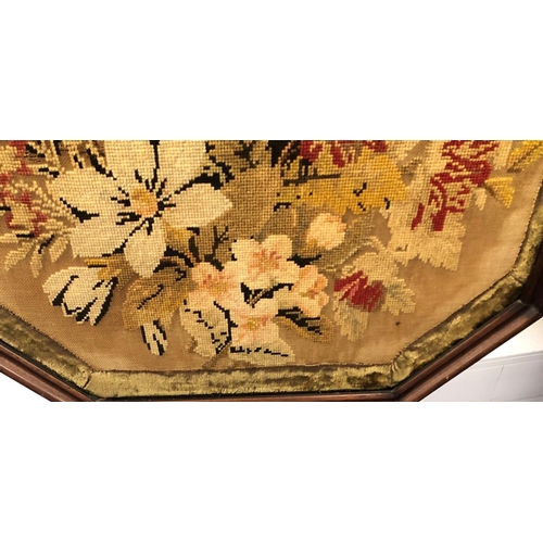 8075 - An adjustable fire pole screen with octagonal needlepoint floral centre panel, 149cm high overall.