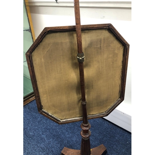 8075 - An adjustable fire pole screen with octagonal needlepoint floral centre panel, 149cm high overall.