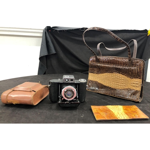 8091 - A vintage crocodile skin handbag, a similar wallet and an Agilux Agifold camera No.49476 (clip to cl... 