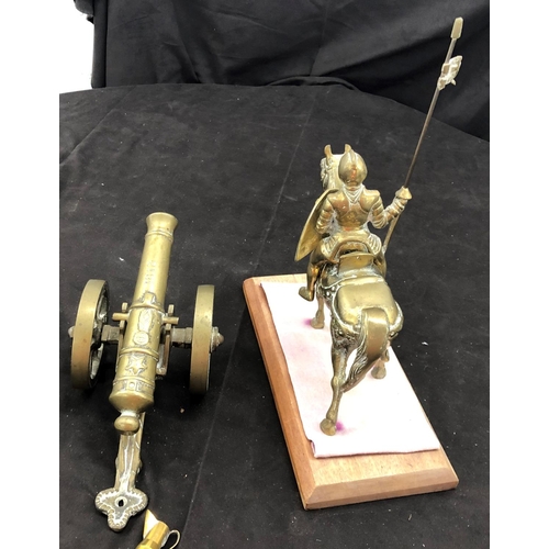 8099 - A solid brass knight on horse, 32cm high overall, with wood base, a brass table top canon etc.