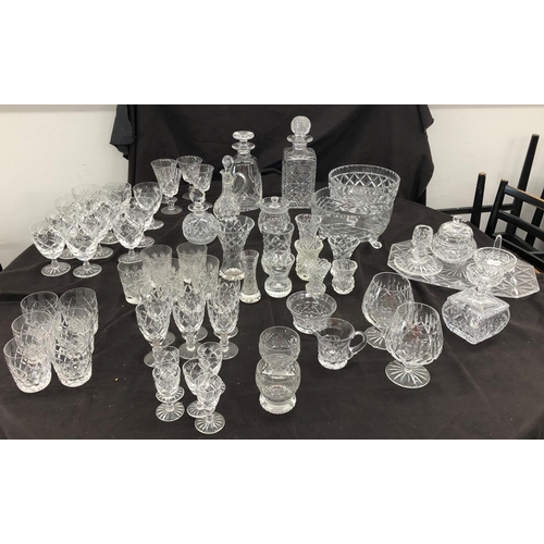 8111 - A large quantity of cut glass, 2 decanters, a part dressing table set, small wine glasses, vases etc... 