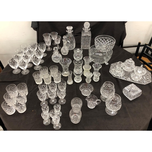 8111 - A large quantity of cut glass, 2 decanters, a part dressing table set, small wine glasses, vases etc... 