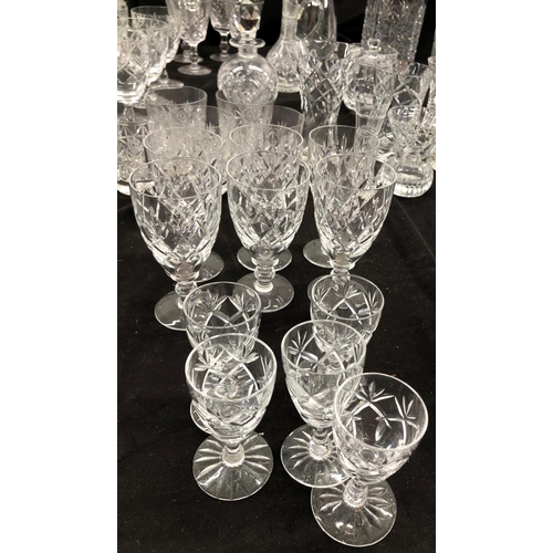 8111 - A large quantity of cut glass, 2 decanters, a part dressing table set, small wine glasses, vases etc... 