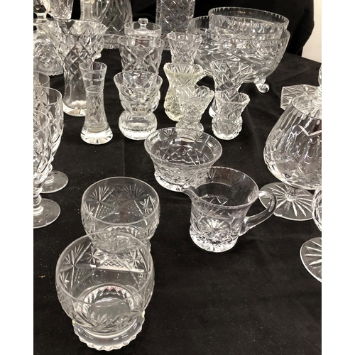 8111 - A large quantity of cut glass, 2 decanters, a part dressing table set, small wine glasses, vases etc... 