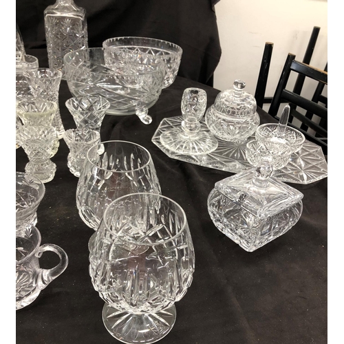 8111 - A large quantity of cut glass, 2 decanters, a part dressing table set, small wine glasses, vases etc... 