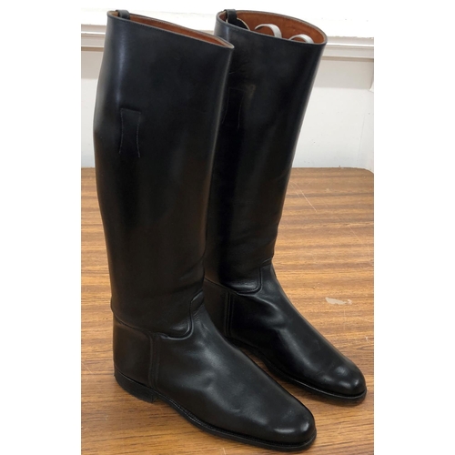 8115 - A pair of black leather riding boots, stamped to Interior 