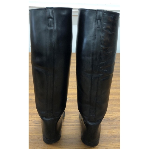 8115 - A pair of black leather riding boots, stamped to Interior 