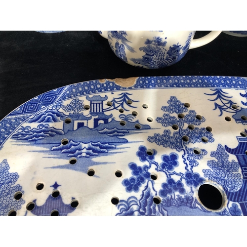 8119 - A quantity of blue and white china including a Spode meat platter (chipped), other Spode, Mason's an... 