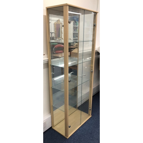 8122 - A modern display cabinet, 168cm high, 64.5cm wide, 32.5cm deep, with 2 glass doors enclosing interio... 