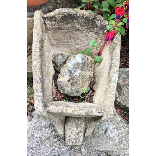 8197 - A stone garden ornament in the shape of a wheelbarrow, 55cm long overall, 23.5cm high. This item is ... 