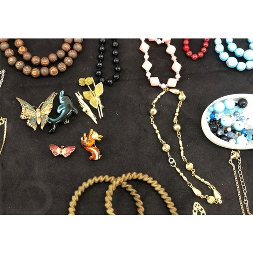 8065 - A large quantity of costume jewellery, necklaces, bracelets, brooches, earrings etc. and a jewellery... 