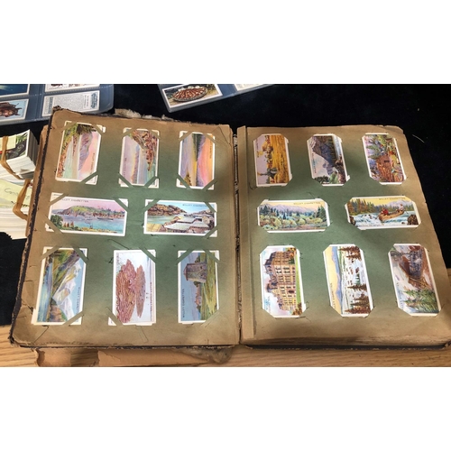 8275 - A leather bound Cigarette card album (album in poor condition) containing Will's First Aid, Overseas... 