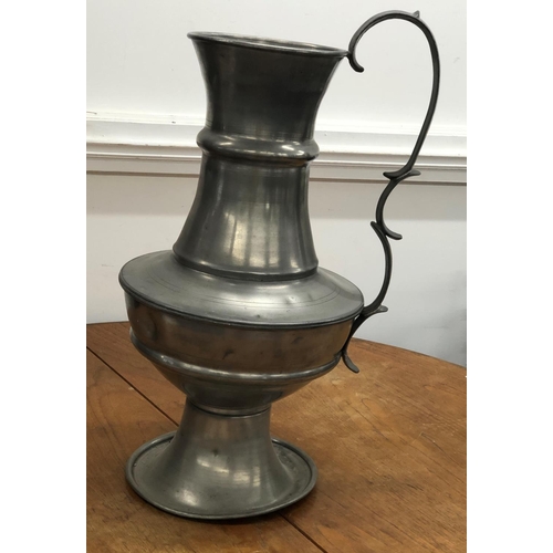 8277 - A large pewter vase, 62cm high (various dents to sides).