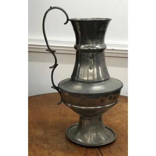 8277 - A large pewter vase, 62cm high (various dents to sides).