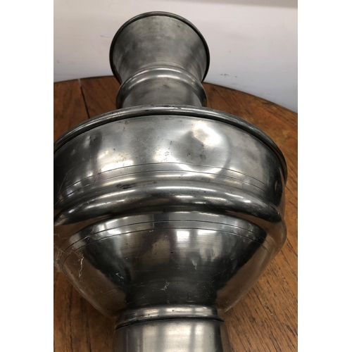 8277 - A large pewter vase, 62cm high (various dents to sides).