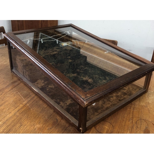 8290 - A display cabinet with key, brown fabric interior, 62cm deep, 46cm wide, 23cm high overall.