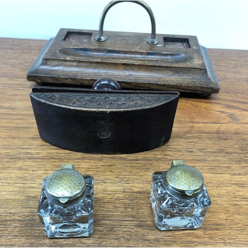 8295 - An oak inkwell stand with 2 glass ink bottles and a carved wood blotter.