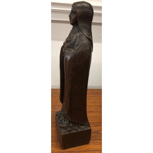 8298 - A wood carved figure 30cm high inscribed A.de Taeys.