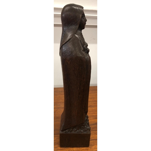 8298 - A wood carved figure 30cm high inscribed A.de Taeys.