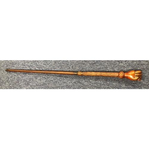 8301 - 20th Century carved wood cane with clenched fist handle, 83.5cm long (wood split to back of hand).