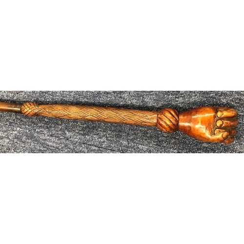 8301 - 20th Century carved wood cane with clenched fist handle, 83.5cm long (wood split to back of hand).