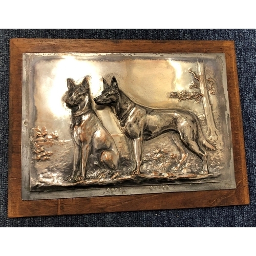 8303 - A copper plaque of 2 German shepherd dogs, F. Diller and numbers stamped to base, on wood plate, 21.... 