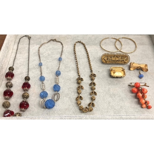 8310 - 3 necklaces, a pair of gold coloured hoop earrings and 4 various brooches.