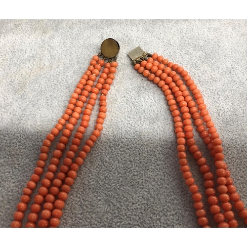 8311 - A 4 string coral necklace, 44cm long overall.