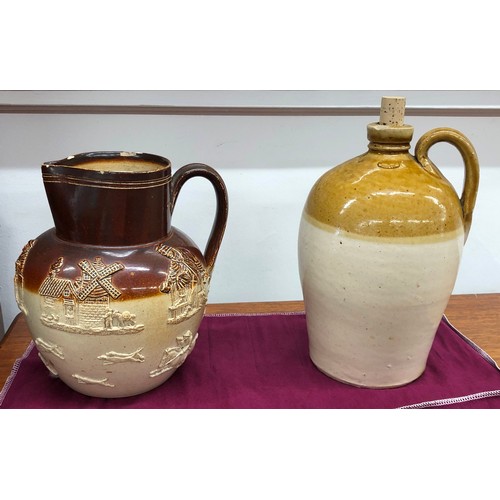 8330 - A Doulton Lambeth earthenware jug, 22cm high (chipped to rim) and a stoneware storage jar impressed ... 