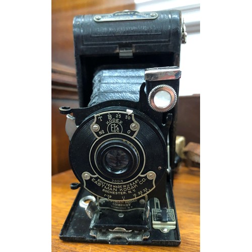 8329 - An Eastman Kodak Company camera with brown leather case, an Ensign box camera with canvas case, a Ca... 