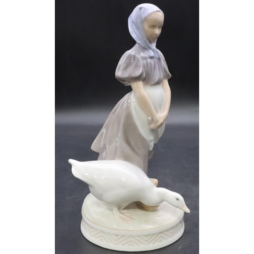 102 - A Royal Copenhagen figure of a young girl with a goose, number 527, 23cm high