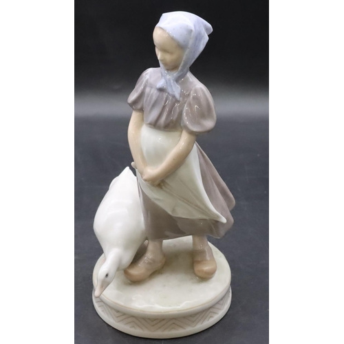 102 - A Royal Copenhagen figure of a young girl with a goose, number 527, 23cm high