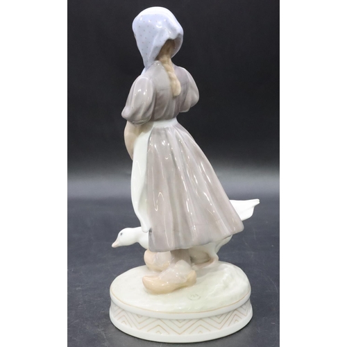 102 - A Royal Copenhagen figure of a young girl with a goose, number 527, 23cm high